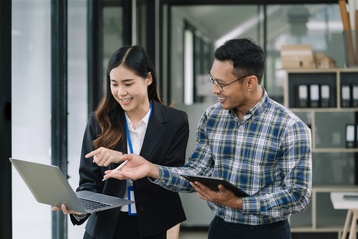 Two business professionals working together in a modern office setting